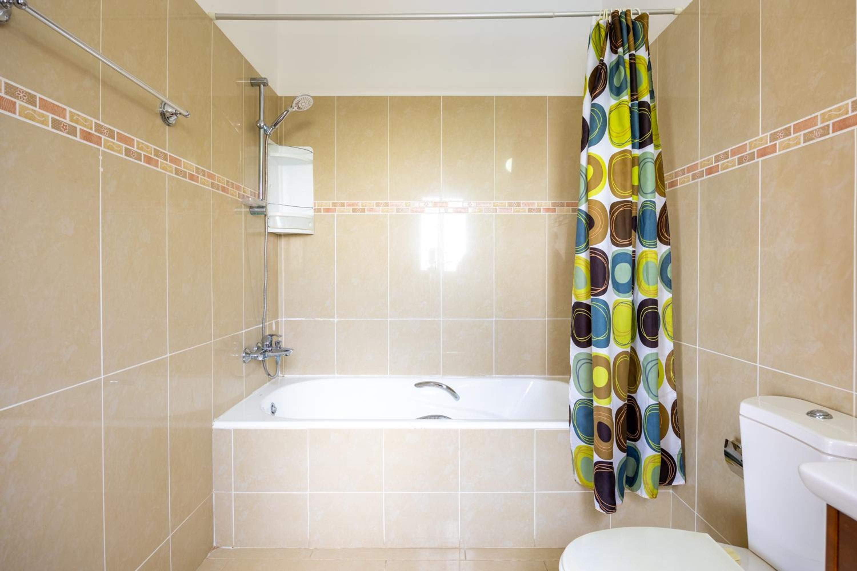 A bathroom with a bathtub, toilet, and shower.