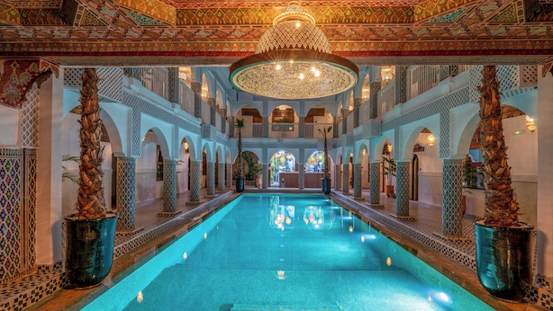 An indoor swimming pool with ornate ceiling and walls, surrounded by columns and arches. - Palais Moulay Said & SPA (Marrakech)