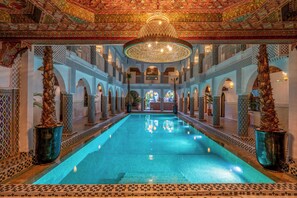 An indoor swimming pool with ornate ceiling and walls, surrounded by columns and arches. - Palais Moulay Said & SPA (Marrakech)