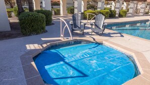 A swimming pool with a blue cover, lounge chairs, and a no-jumping sign. - Cozy House, Pool, Spa, Tennis & Pickleball Courts (Tempe)