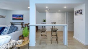 A modern living room with a sofa, a coffee table, and a painting on the wall. - 3 bedroom 2.5 bath townhome (Rockport)