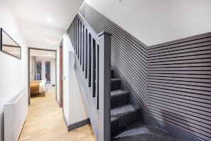 Stunning staircase with sleek, modern design and horizontal paneling.