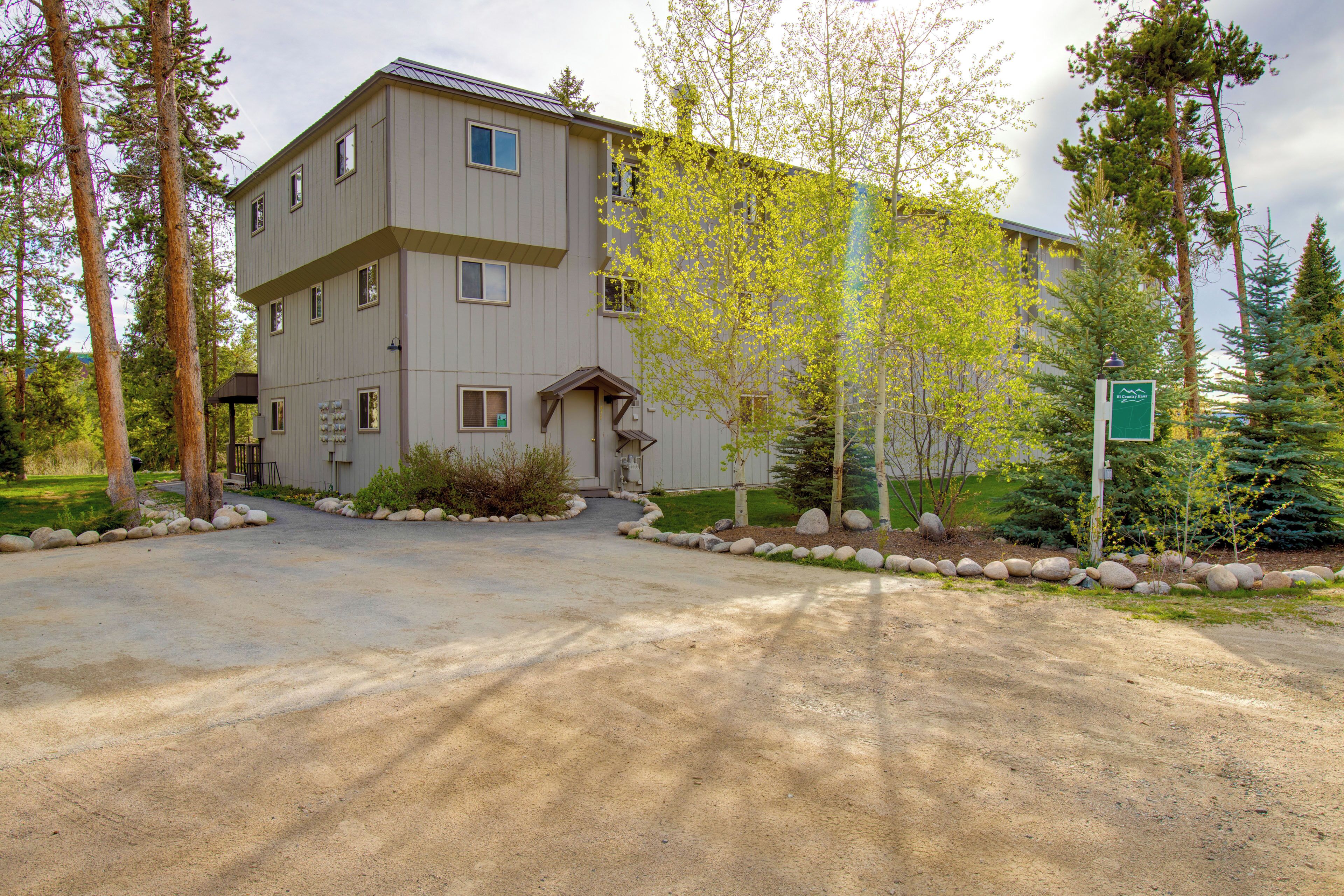 A multi-story building with a driveway leading to the entrance.
