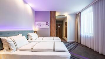 A hotel room with two beds, a headboard, a wall-mounted sign, and a large window with curtains.