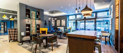 A modern interior with a bar area, seating, and a view through large windows.