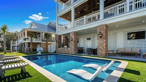 A two-story house with a swimming pool, outdoor seating, and a basketball hoop. - Tyson’s Corner: Luxe Marshfront Retreat w/ Pool (Murrells Inlet)