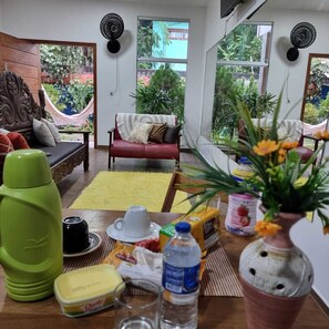 Relax in a comfortable seating area with a sofa and bench, surrounded by a coffee table and natural views.