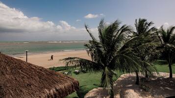 On the beach, white sand, sun loungers, beach umbrellas