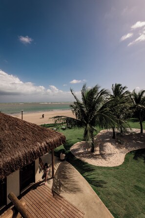 On the beach, white sand, sun-loungers, beach umbrellas