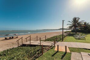 On the beach, white sand, sun loungers, beach umbrellas