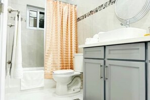 A bathroom with a shower, toilet, and sink. - Private pool island retreat.

 (Nassau)