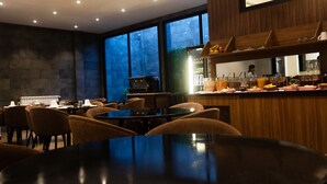 Un restaurant doté d’un bar, de tables et de chaises.