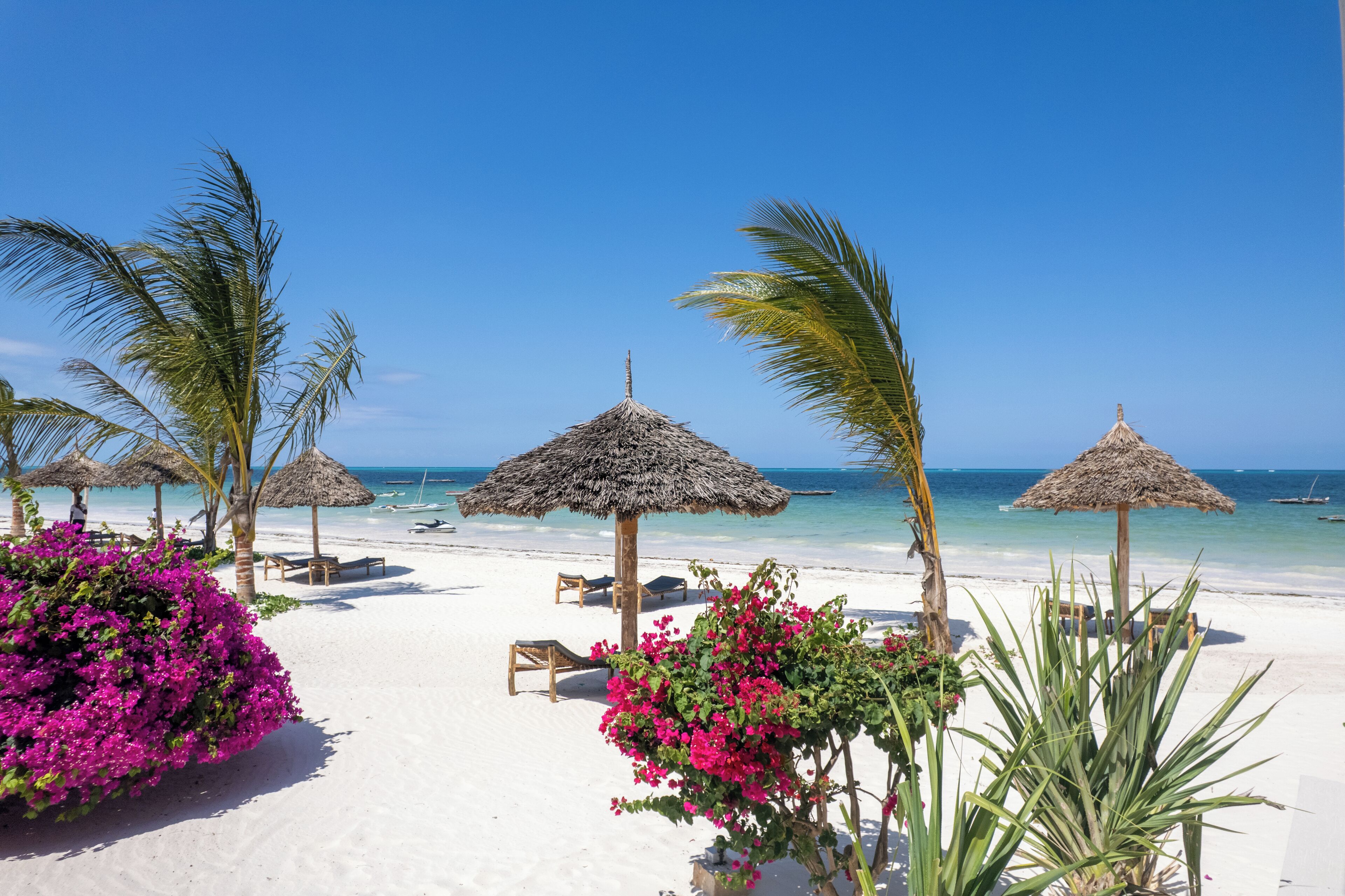 On the beach, white sand, sun-loungers, beach umbrellas