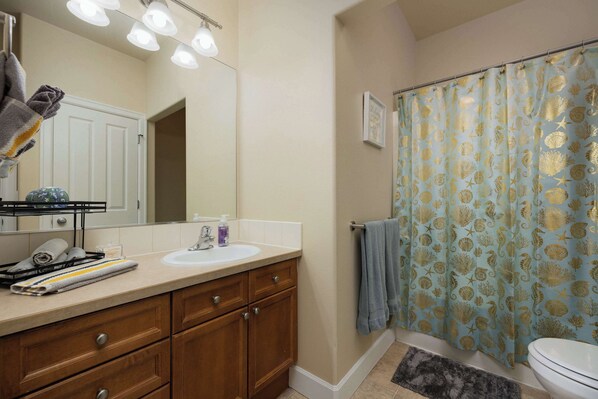 A bathroom with a sink, mirror, and shower curtain. - Charming Bend Sanctuary for 6! (Bend)