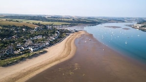 An aerial view of a coastal town with a sandy beach, a river, and boats. - Cottage with 3 ensuite bedrooms and Sea Views.  North Devon Heritage Coast. (Bideford)