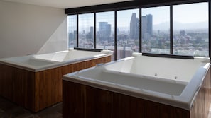 Enjoy a luxurious stay with two separate bathtubs and stunning city views.