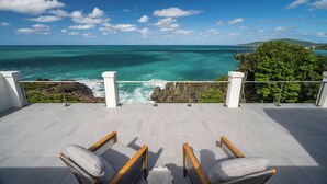 A balcony with two wicker chairs and a view of the ocean. - Beautiful SeaCrown Estate-Oceanfront- 6BR 5.5BA with Pool (St Thomas)