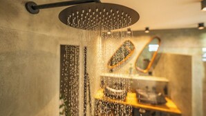 A modern shower with a curved design and multiple water jets. - Your own private beach resort: HIGH-END VILLA CASA CAS ABAO  (Cas Abao)