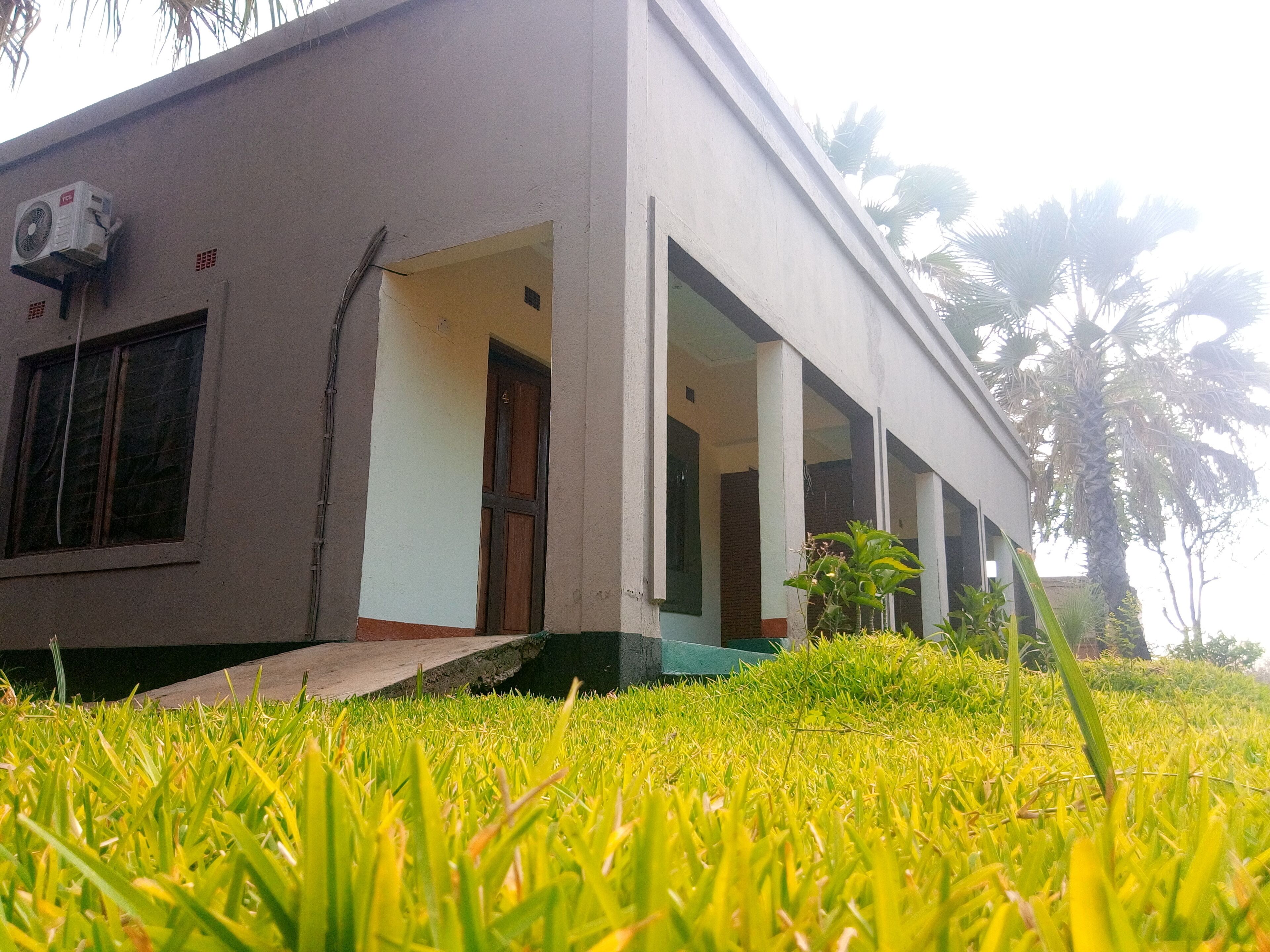 A building with a flat roof, a single entrance, and a small porch area.