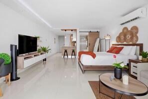A modern bedroom with a bed, bedside table, and a TV.