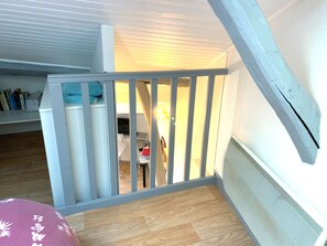 A wooden staircase with a white railing leading to an upper floor. - Fully furnished and equipped studio apartment, right in the town center (limoges)