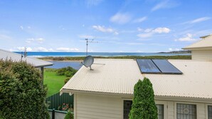 A residential property with a satellite dish, solar panels, and a view of the ocean. - Apollo Bay Guesthouse (Apollo Bay)