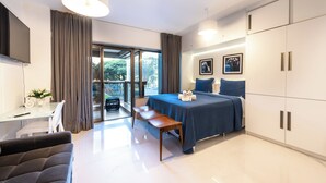 A modern bedroom with a bed, a desk, a chair, and a bench. - 112 Rosemari's Apartments Studio Premium Centro SP Garage & Pool & Gym (República São Paulo)