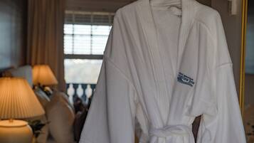 A white bathrobe hanging on a rack with a label that reads "GREAT MOUNTAIN OVERVIEW INN".