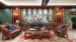 A luxurious room with a large ornate painting, a red carpet, and classic furniture. - Days Hotel By Wyndham Harbin Qunli (Harbin)