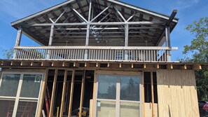 A two-story building with a balcony, wooden beams, and large windows. - #3 - 3 bedroom upper unit , right on the C5a snowmobile trail. 11 miles off 81. (Lacona)