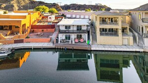 A waterfront property with a pool, a two-story building, and a view of the surrounding area. - Multi-Home Retreat on Colorado River w/ Boat Dock! (Parker)