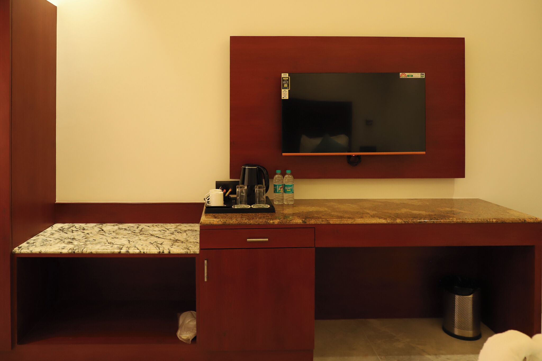 A compact kitchenette with a built-in microwave, a coffee maker, and a small refrigerator.