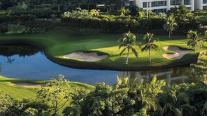 A cable car system, a golf course, and a modern hotel with multiple floors and balconies.