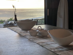 A dining table with several bowls and a vase, set on a balcony overlooking a scenic view. - Villa Del Mar 3. 180 Ocean View, Gated community (Savegre de Aguirre)