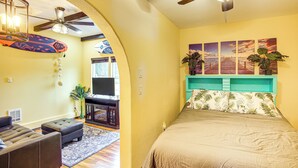 A bedroom with a bed, a ceiling fan, a TV, and a desk with a chair. - Electric Fireplace: Central Coeur d'Alene Studio! (Coeur d'Alene)