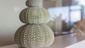 A stack of three spherical objects with a textured surface, placed on a flat surface.