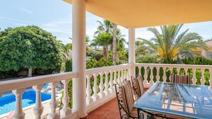 A covered outdoor area with a pool, white balustrade, and seating. - Holiday Home 'Limonita' with Private Pool, Wi-Fi and Air Conditioning (Mutxamel)