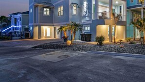 A multi-story residential building with a modern design, featuring balconies and large windows. - Ocean view, Tiki, Heated Pool, Game Room - The Seahorse - Roelens (Fort Myers Beach)