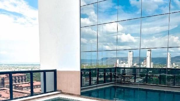 A rooftop pool with a clear view of the city skyline.
