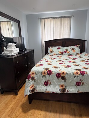 A bedroom with a bed, dresser, and a mirror. - Home away from Home-YYZ Airport (Mississauga)