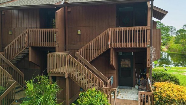 A two-story wooden building with a staircase leading to the upper floor.