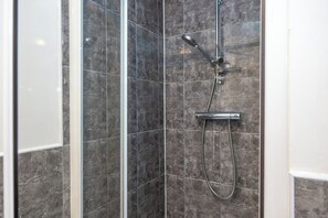 Chuveiro, secador de cabelo, toalhas de banho
