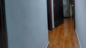 A narrow hallway with a wooden floor and light blue walls. - House 2nd level near AILA!!!! (Santo Domingo Este)
