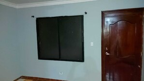 A room with a dark-colored door and a window with a black frame. - House 2nd level near AILA!!!! (Santo Domingo Este)