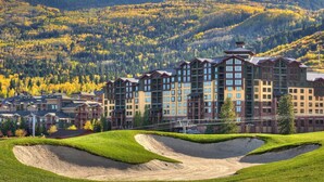 A multi-story hotel with a modern architectural design, featuring a prominent entrance and multiple balconies.