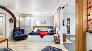 A cozy living room with a sofa, a small table, and a bench.