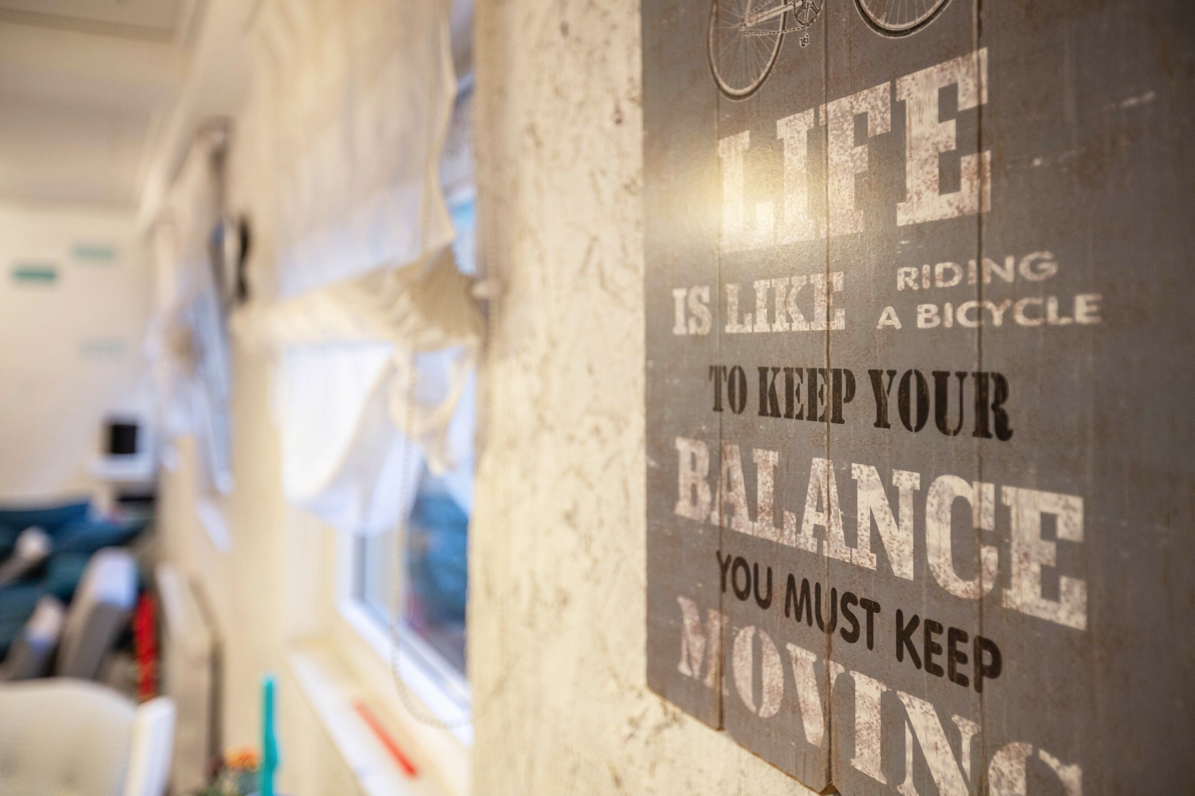 A sign with motivational text on a wall.