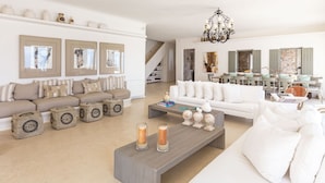 A spacious living room with a sofa set, a coffee table, and decorative items. - Villa in Kalafati with 8 bedrooms sleeps 16 (Kalafati)