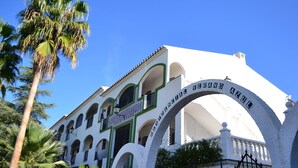 A building with a white facade, green accents, and a sign reading "Residencial Verde Azul". - Sunny 2 bed apartment in a complex with pools close to village centre and beach. (Nerja)