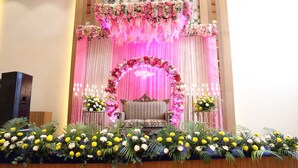A stage with floral decorations and a bench, likely for a ceremony or event. - Hotel Chandraa Celebration (Dehradun)